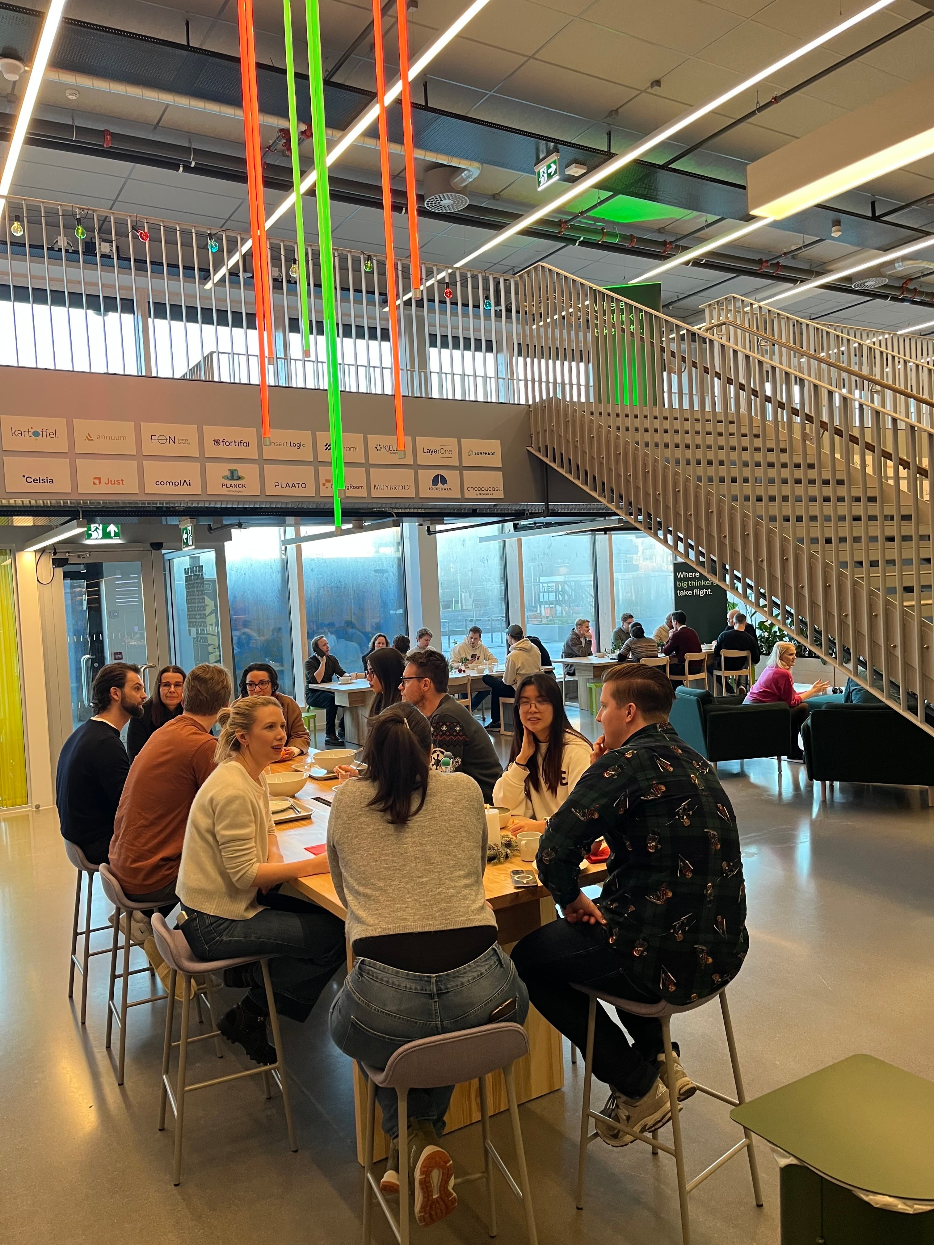 Founders co-working at high tables in the Tech Hub