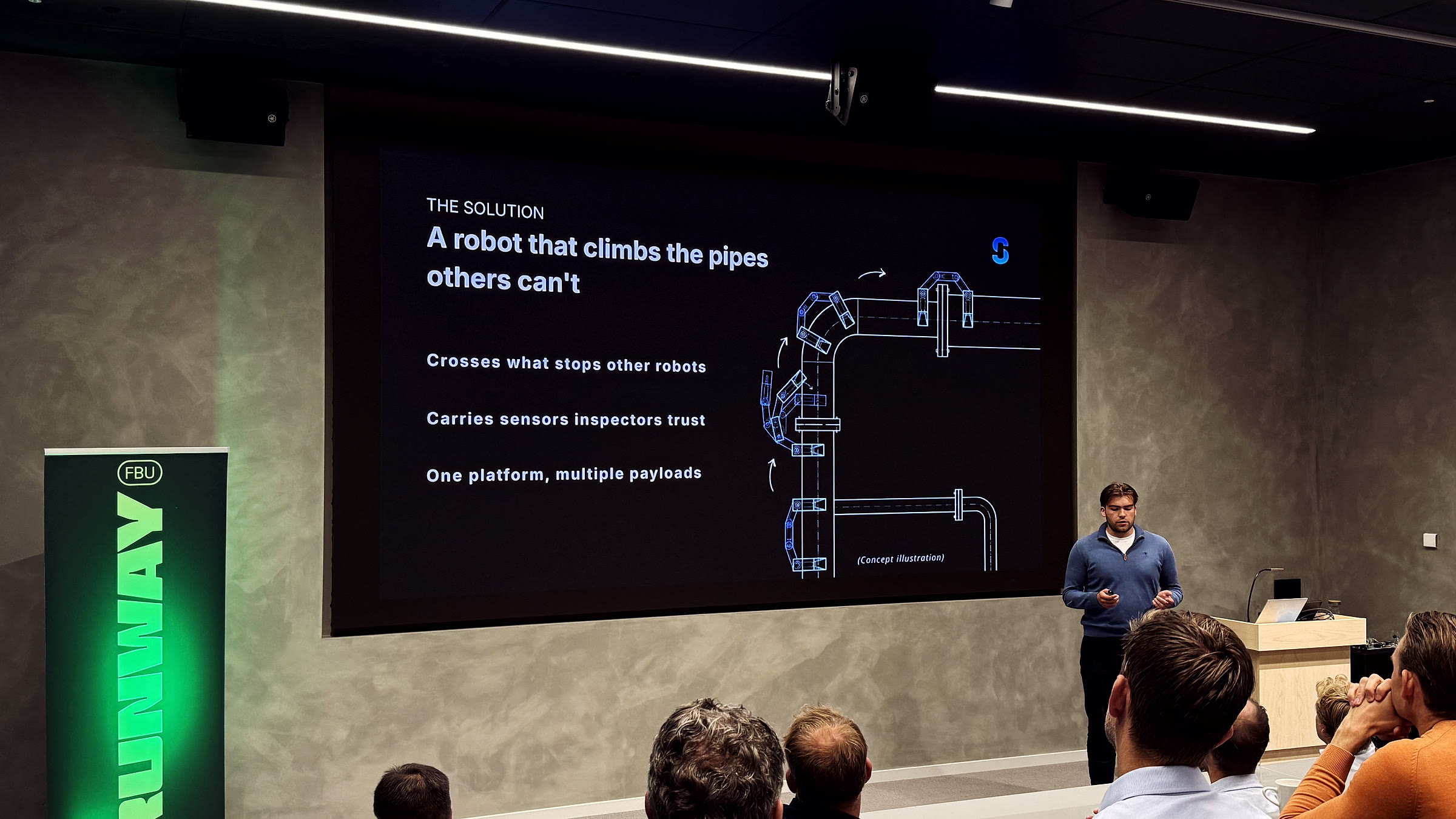 Kristian Romen from Saro Robotics presenting a slide titled ‘A robot that climbs the pipes others can’t’ with a concept illustration.